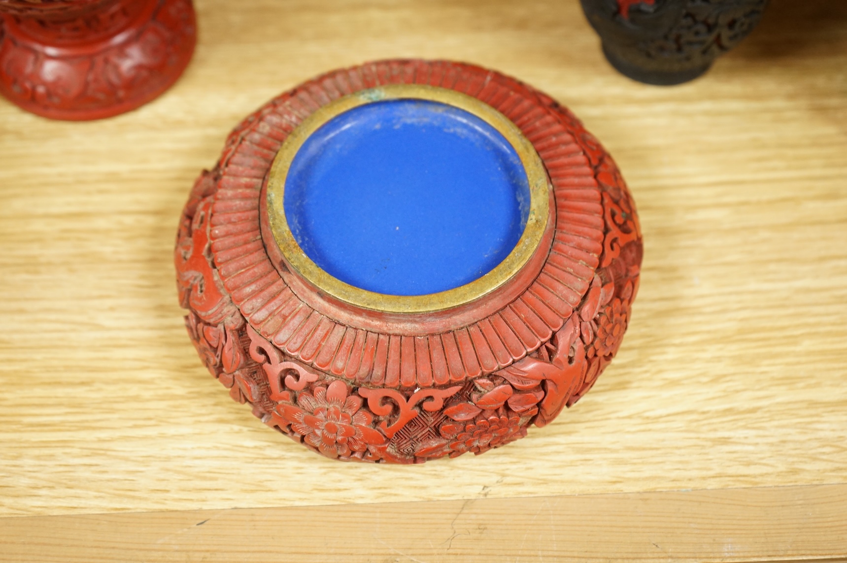 Two Chinese cinnabar lacquer vases and an ashtray, largest 20cm high